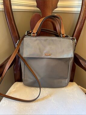 Khaki Tumi nylon crossbody bag with detachable leather strap, zipper top